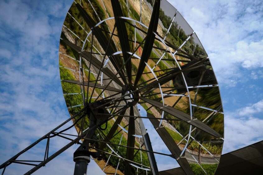 Circular mirror against blue sky