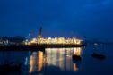 Royal Dutch Shell Plc's Prelude floating liquefied natural gas (FLNG) facility is illuminated at dusk at the Samsung Heavy Industries Co. shipyard in Geoje, South Korea, on Tuesday, June 27, 2017. Samsung Heavy is one of the world's three biggest shipbuilders. Photographer: SeongJoon Cho/Bloomberg
