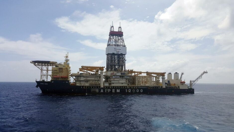 Drillship on sea under cloudy sky