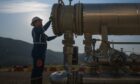 Worker stands at end of big pipe
