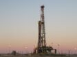 A rig silhouetted against dusk