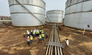 Storage tanks with people in high vis jackets