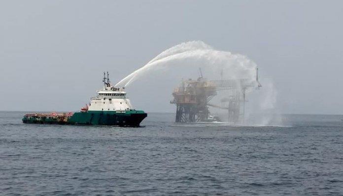 A vessel sprays water onto a platform