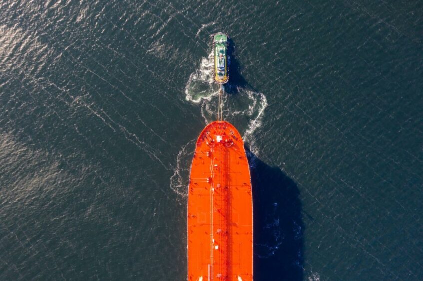A tug boat tows an AET Tankers Pte liquid natural gas (LNG) dual-fuelled aframax vessel near the Samsung Heavy Industries Co. shipyard in this aerial photograph taken in Geoje, South Korea, on Friday, Feb. 1, 2019. Korea Development Bank (KDB) has contacted Samsung Heavy on whether it would be interested in Daewoo Shipbuilding & Marine Engineering Co. before the bank makes a definitive decision on its stake. Samsung Heavy will review KDB's proposal for Daewoo, the company said in a text message.