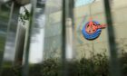 Signage for Cnooc Ltd. is displayed on the company's headquarters in Beijing, China, on Tuesday, July 24, 2012. Photographer: Nelson Ching/Bloomberg