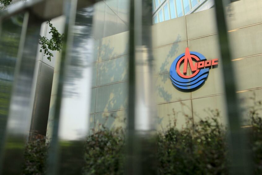 Signage for Cnooc Ltd. is displayed on the company's headquarters in Beijing, China, on Tuesday, July 24, 2012. Photographer: Nelson Ching/Bloomberg