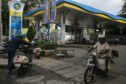 A motorcyclist rides out of a Bharat Petroleum gas station in Bengaluru, India, on Wednesday, Oct. 13, 2021. The rupee has come under pressure as surging commodity prices rekindled worries about inflation and the financial health of the net oil-importing nation.