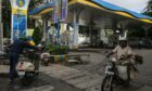 A motorcyclist rides out of a Bharat Petroleum gas station in Bengaluru, India, on Wednesday, Oct. 13, 2021. The rupee has come under pressure as surging commodity prices rekindled worries about inflation and the financial health of the net oil-importing nation.
