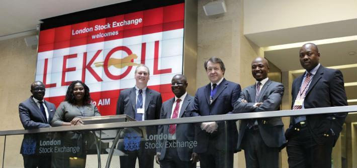 People stand on balcony in front of display saying Lekoil