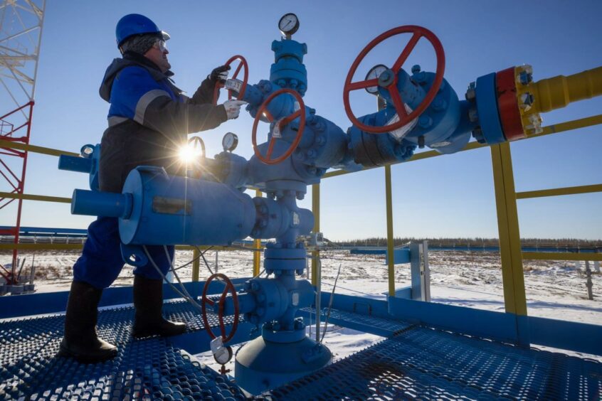 A worker turns a valve wheel at a gas well on the Gazprom PJSC Chayandinskoye oil, gas and condensate field, a resource base for the Power of Siberia gas pipeline, in the Lensk district of the Sakha Republic, Russia, on Tuesday, Oct. 12, 2021.