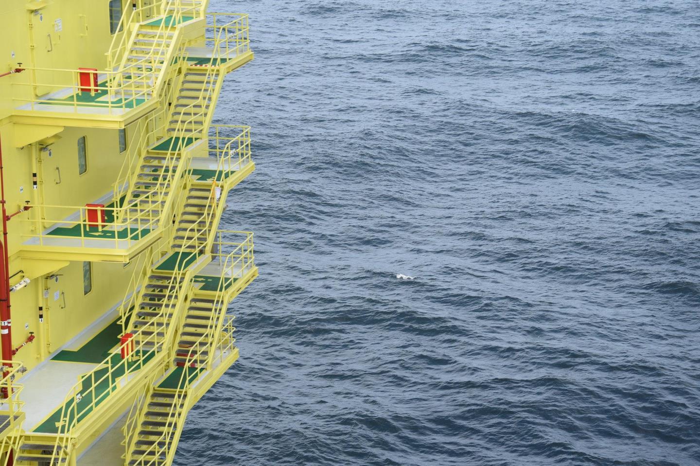 Yellow construction over a blue sea