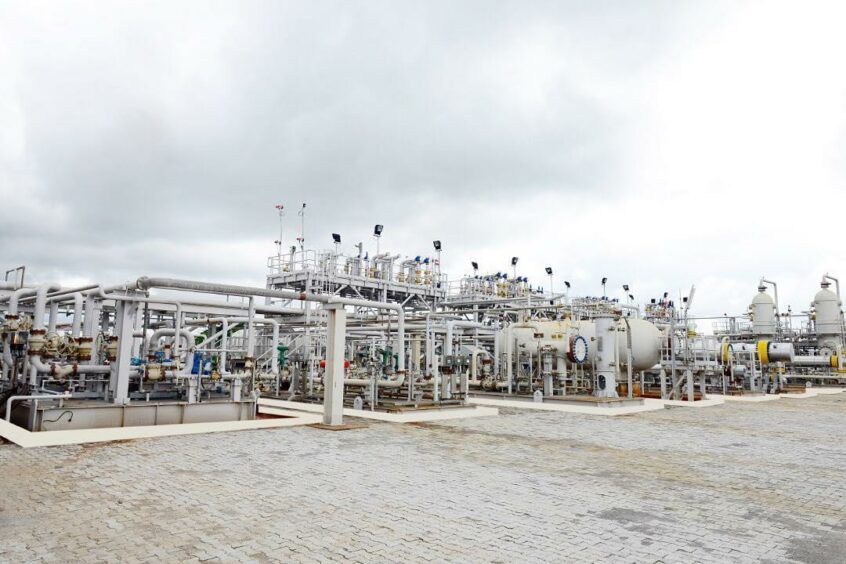 Industrial facility with pipes under an overcast sky