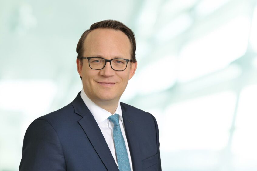 Head shot of man with blue tie 