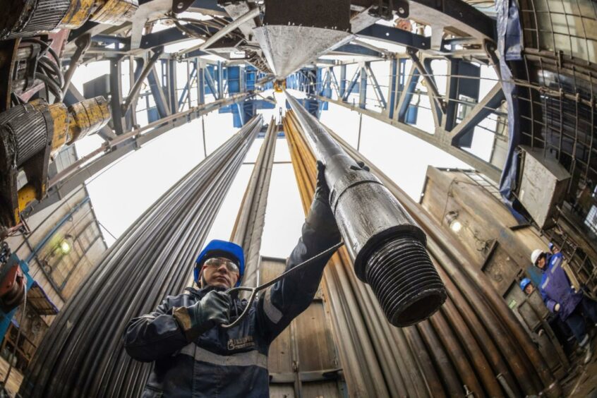A worker guides drilling pipes at a gas drilling rig on the Gazprom PJSC Chayandinskoye oil, gas and condensate field, a resource base for the Power of Siberia gas pipeline, in the Lensk district of the Sakha Republic, Russia, on Wednesday, Oct. 13, 2021. European natural gas futures declined after Russia signaled that it may offer additional volumes soon. Photographer: Andrey Rudakov/Bloomberg