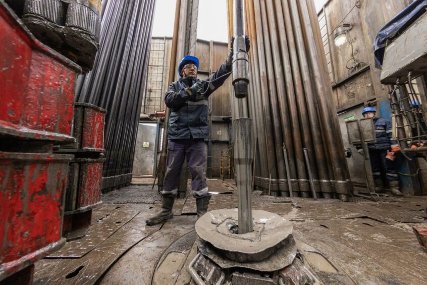A worker guides drilling pipes at a gas drilling rig on the Gazprom PJSC Chayandinskoye oil, gas and condensate field, a resource base for the Power of Siberia gas pipeline, in the Lensk district of the Sakha Republic, Russia, on Wednesday, Oct. 13, 2021.