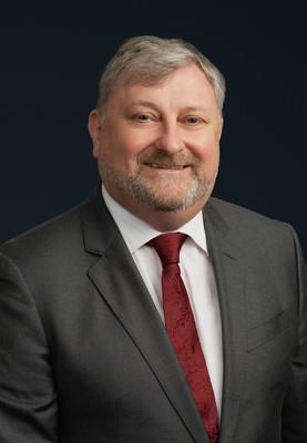 Head shot of man with red tie