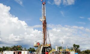 ReconAfrica's onshore drilling rig under blue sky