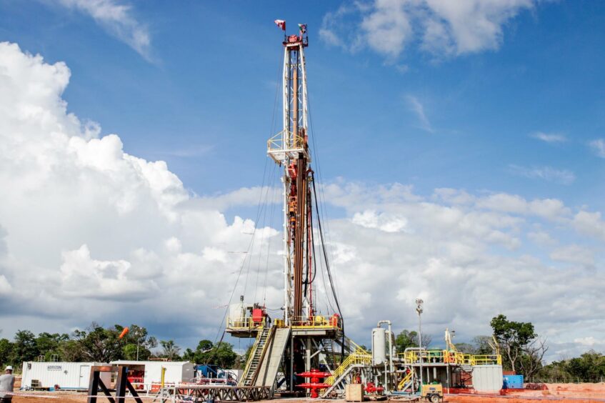 ReconAfrica's onshore drilling rig under blue sky