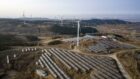 Wind turbines and solar panels in Liaoning Province. Photographer: Qilai Shen/Bloomberg