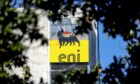 The ENI SpA logo sits on the company's headquarters office building seen through trees in Rome, Italy, on Friday, April 24, 2020. Photographer: Alessia Pierdomenico/Bloomberg