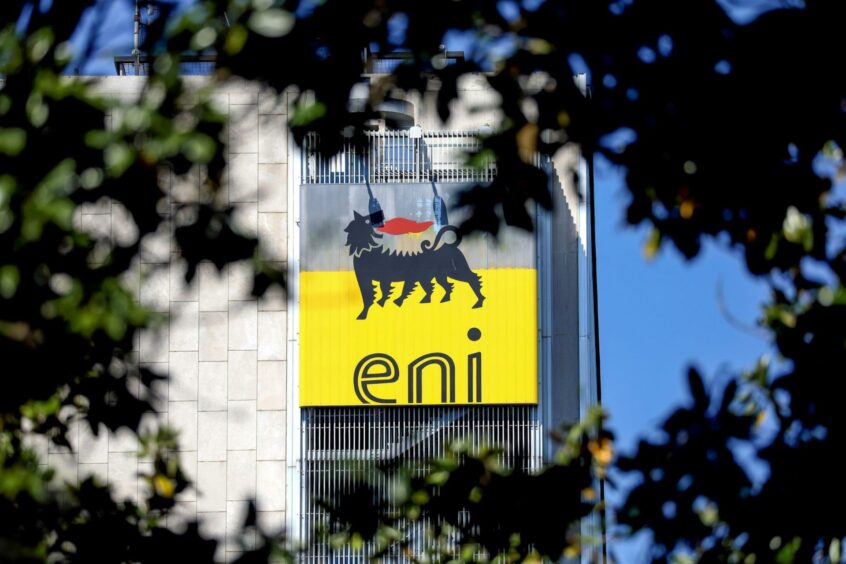 The ENI SpA logo sits on the company's headquarters office building seen through trees in Rome, Italy, on Friday, April 24, 2020. Photographer: Alessia Pierdomenico/Bloomberg