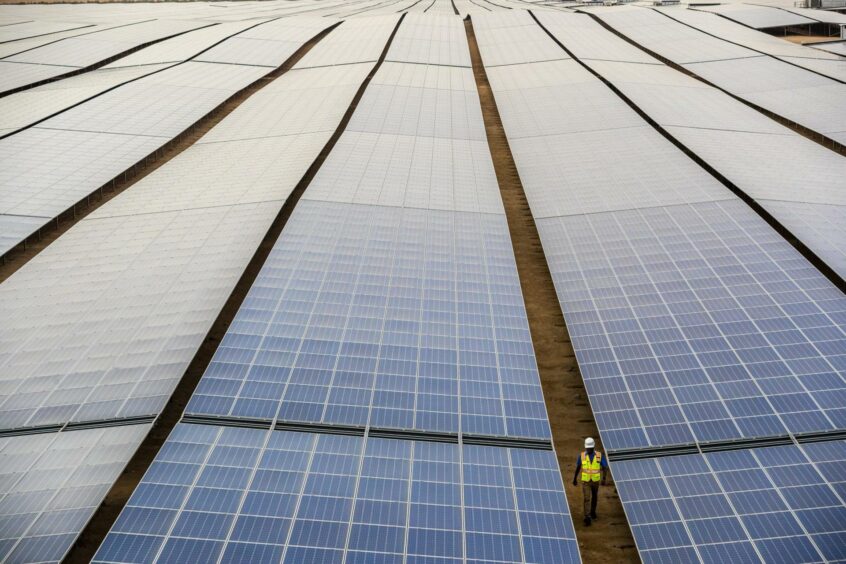 Solar panels with a worker for scale