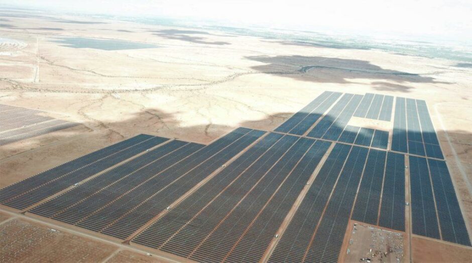 Solar panels from the air, under a cloud