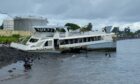 Catamaran wrecked with children playing around it