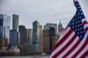 American Flag with Manhattan in background.