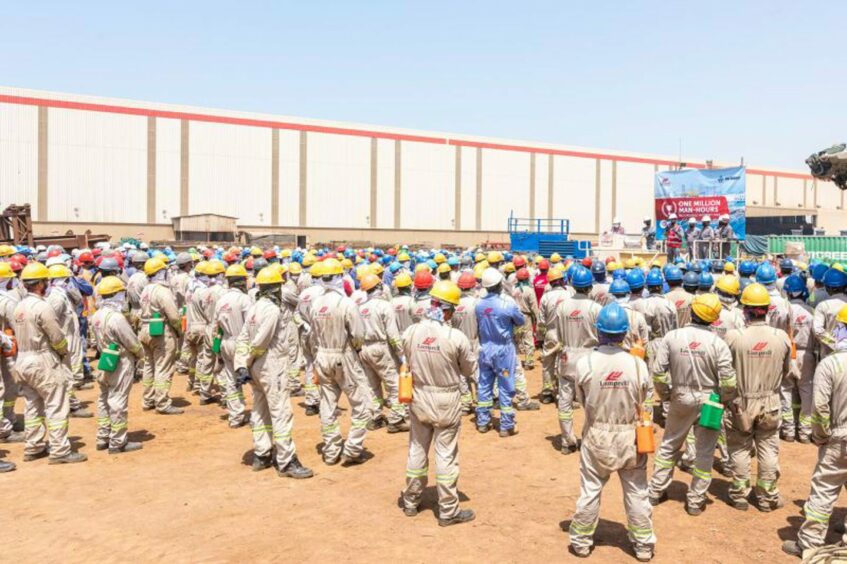 Workers stand in the sun