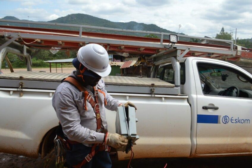 Man in hard hat next to pickup