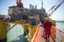 Workers on the Shell Vito offshore oil platform docked at Kiewit Offshore Services while under construction in Ingleside, Texas, on April 6, 2022