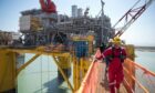 Workers on the Shell Vito offshore oil platform docked at Kiewit Offshore Services while under construction in Ingleside, Texas, on April 6, 2022