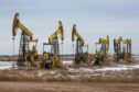 Oil pumping jacks, also known as 'nodding donkeys'in a Rosneft Oil Co. oilfield near Sokolovka village, in the Udmurt Republic, Russia, on Friday, Nov. 20, 2020. Photographer: Andrey Rudakov/Bloomberg