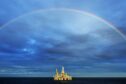 Somewhere over the rainbow. The picture depicts a perfect rainbow arch over Ocean Onyx rig in the Bass Strait, offshore Victoria. Australia.