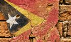 East Timor flag mural on old wall.