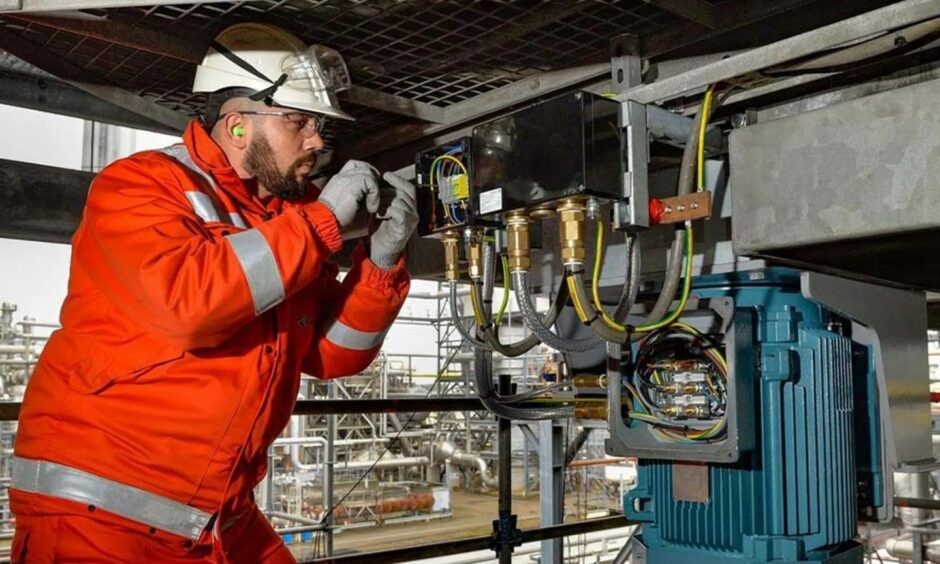 Worker in orange attends to business