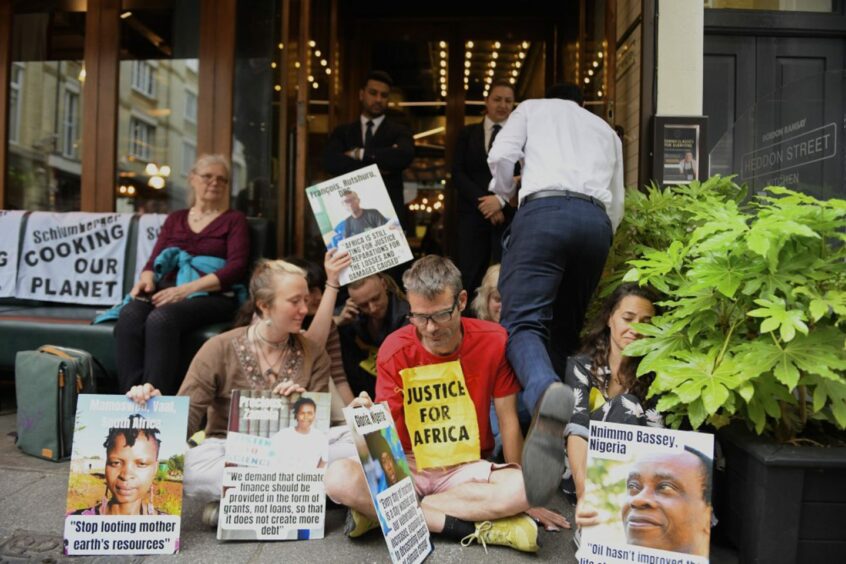 Protestors sit in front of doors