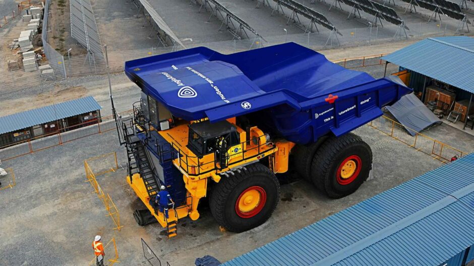 Big blue truck with man for scale 