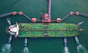 This aerial photo taken on August 4, 2019 shows tugboats berthing an oil tanker at Qingdao port in Qingdao in China's eastern Shandong province.  Photographer: STR/AFP/Getty Images