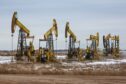 Oil pumping jacks, also known as "nodding donkeys"in a Rosneft Oil Co. oilfield near Sokolovka village, in the Udmurt Republic, Russia, on Friday, Nov. 20, 2020. Photographer: Andrey Rudakov/Bloomberg