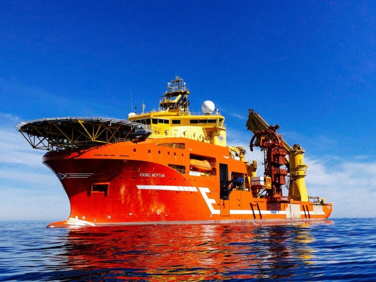 An orange boat on a blue sea and sky