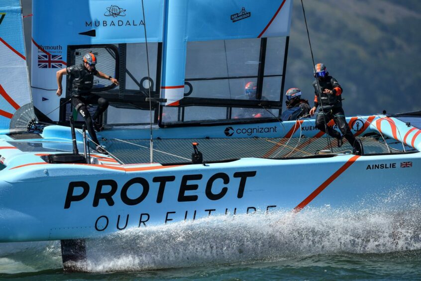 Blue catamaran with people in life jackets