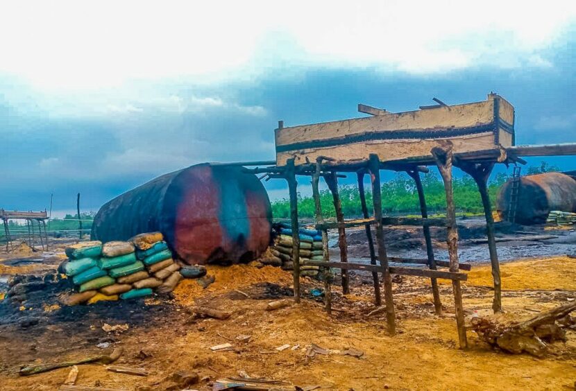 Smoking ruins of destroyed illicit refinery