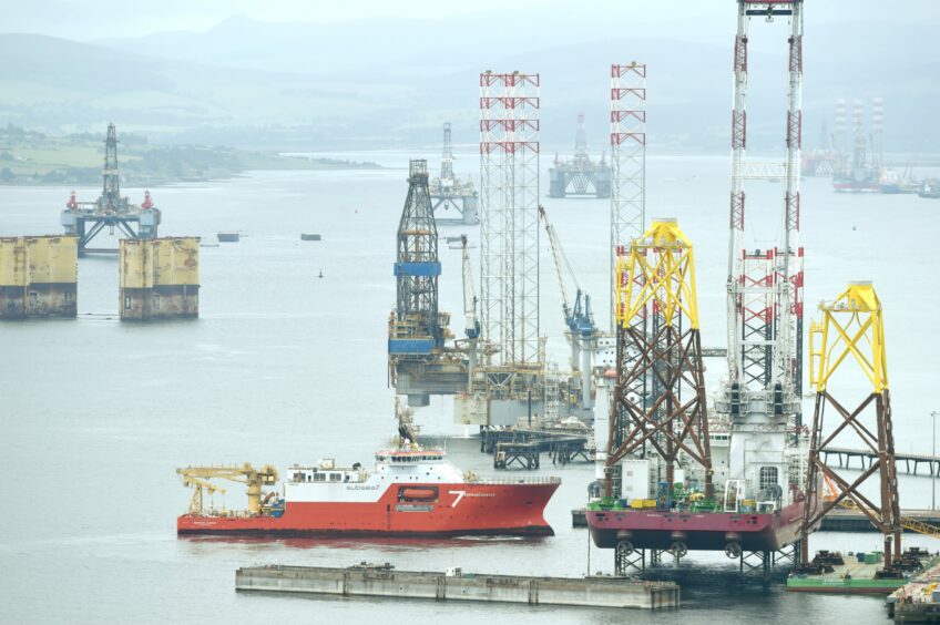 Busy scenes in the Cromarty Firth.  The large floating crane barge, Seajacks Scylla loads wind turbine base platforms at the Nigg Energy Park for the Moray East offshore windfarm The Normand Subsea docks at the Nigg Energy Park.
