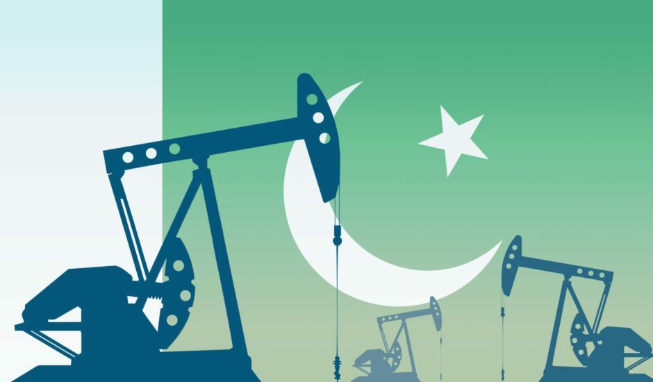 Drilling rigs with Pakistan flag in the background.