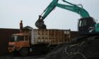 An excavator loads coal onto a dump truck at Cirebon Port in West Java, Indonesia, on Wednesday, May 11, 2022. Trade has been a bright spot for Indonesia, which has served as a key exporter of coal, palm oil and minerals amid a global shortage in commodities after Russia's invasion of Ukraine.