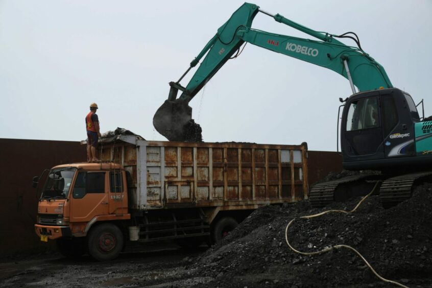 An excavator loads coal onto a dump truck at Cirebon Port in West Java, Indonesia, on Wednesday, May 11, 2022. Trade has been a bright spot for Indonesia, which has served as a key exporter of coal, palm oil and minerals amid a global shortage in commodities after Russia's invasion of Ukraine.