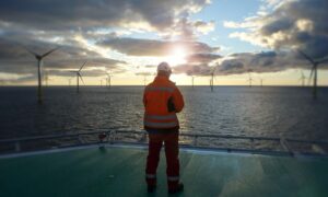 An offshore worker on a wind turbine.