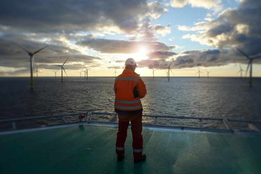 An offshore worker on a wind turbine.